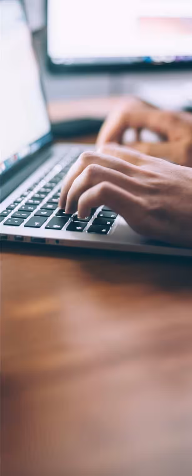 Person typing on a laptop keyboard at Northfield Township Road District.