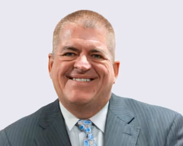 Official of Northfield Township Road District smiling in a suit.